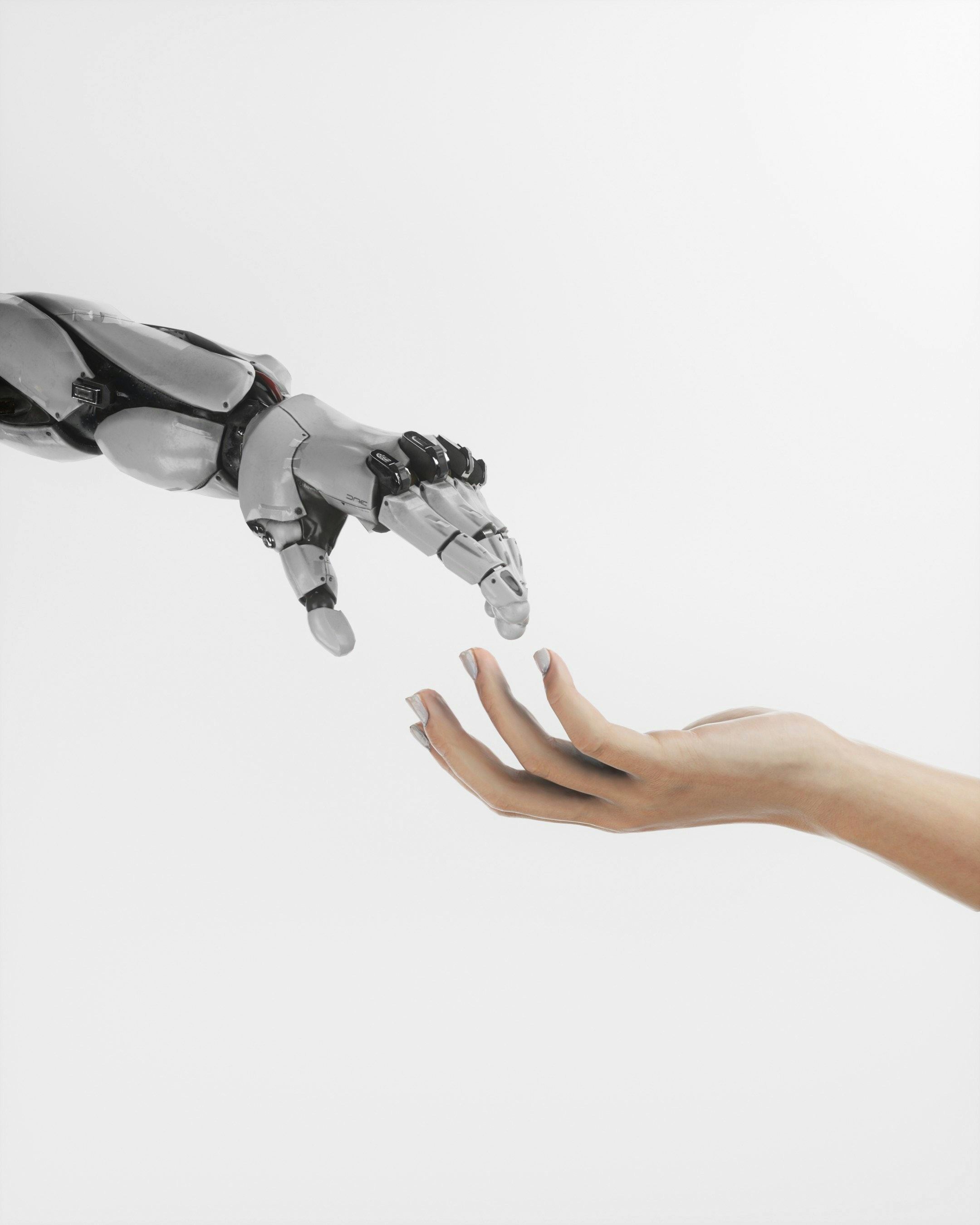 Robot and human hands reaching toward each other