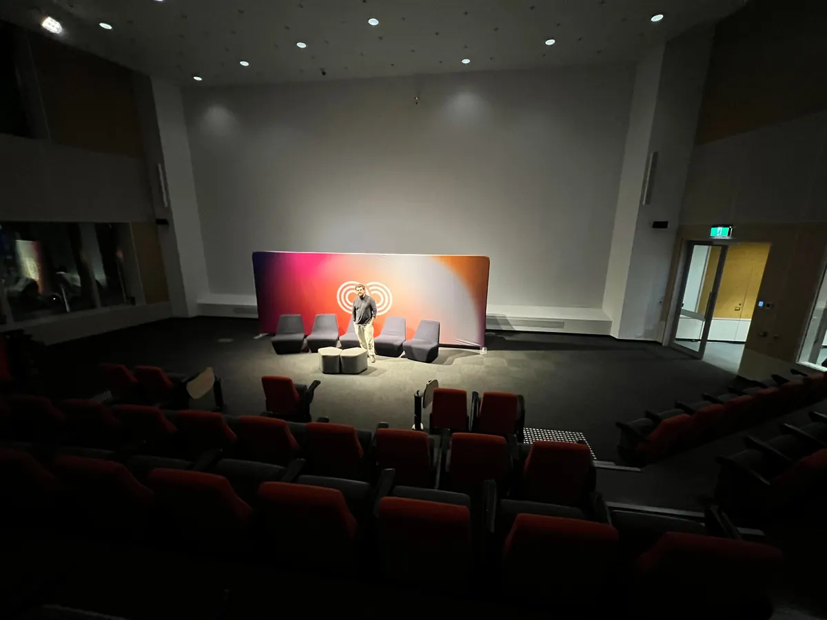 Speaker presenting on the Autistic Pride Day stage, 2025